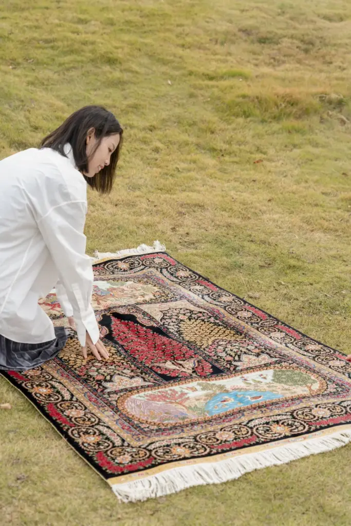 Large handmade silk rug laid flat for quality inspection