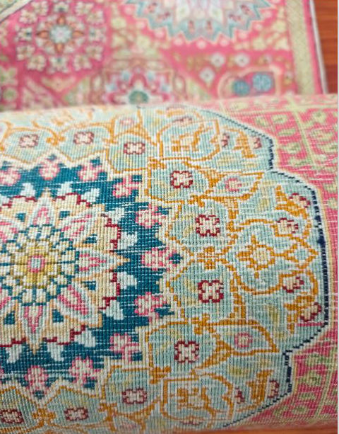 Close view of the fine pile and pattern details on handmade silk rugs