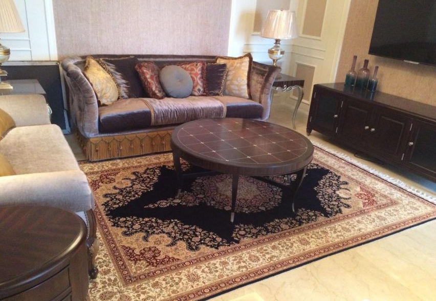 Handmade silk rug placed beneath living room furniture