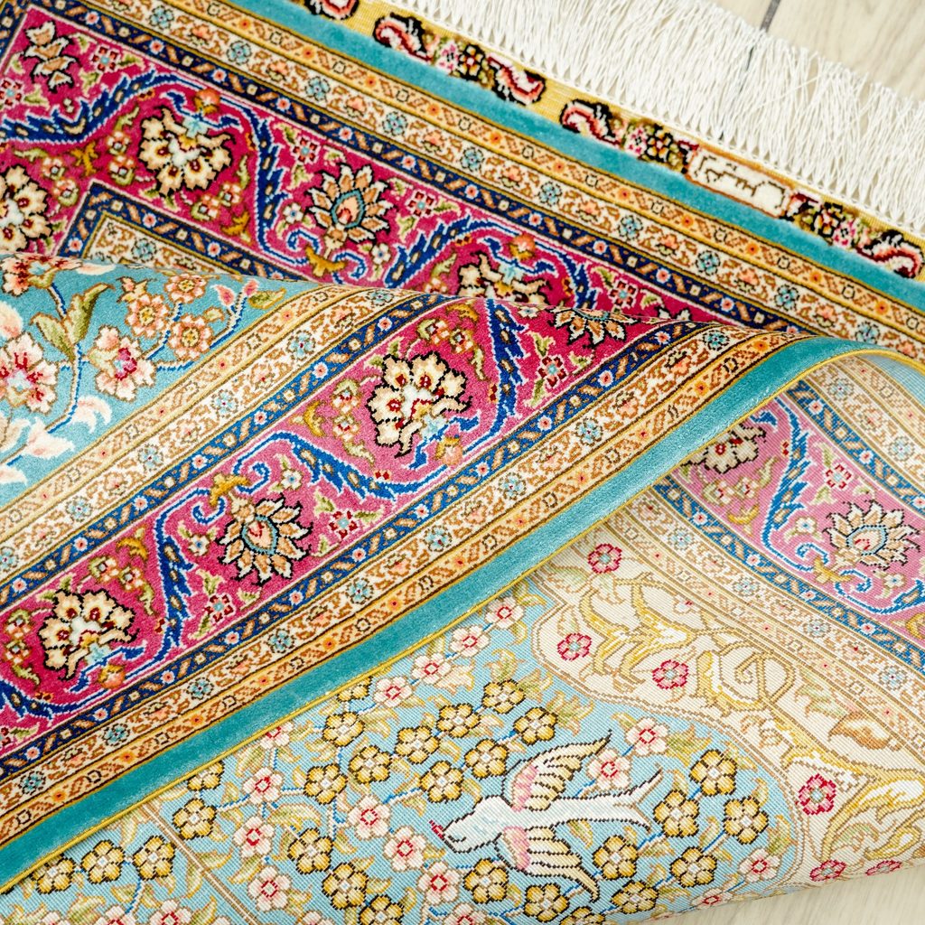 Folded edge showing the flexible construction of a handmade silk rug
