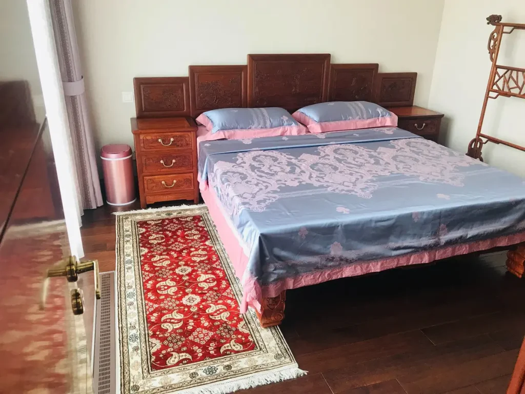 red-silk-runner-rug-beside-bed