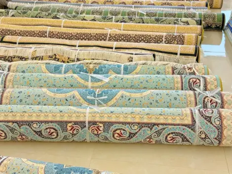 Hand-knotted silk rugs grouped in the YILONG warehouse for shipment to Dubai